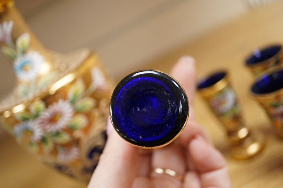 A Royal Worcester peacock painted jar and cover and a Bohemian blue glass decanter and six glasses, with gilt and enamel decoration, decanter 26cm high including stopper. Condition - finial to Worcester pot cover chipped